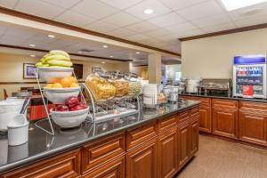 a buffet line with bowls of fruit in a restaurant at Comfort Suites - Near the Galleria in Houston