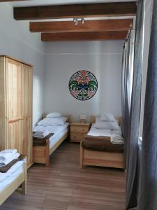 a bedroom with two beds and a mirror on the wall at Apartamenty Stajnia Ojcowizna in Pokrzywnica