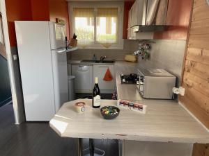 a small kitchen with a counter with a bottle of wine at La Maison d'Arsène in Le Mans +4 photos