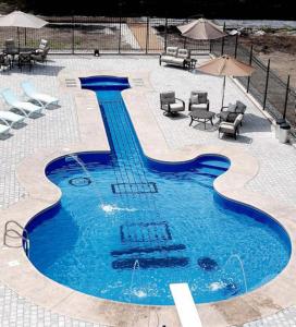 a swimming pool with chairs and umbrellas in a resort at Foton Hotel & Restaurant in Ochakiv