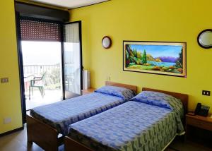 Postel nebo postele na pokoji v ubytování HOTEL COLLI FIORITI + 21 fotografií
