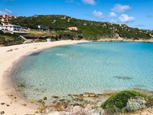 a beach with a large pool of water at Stella Guest House in Santa Teresa Gallura