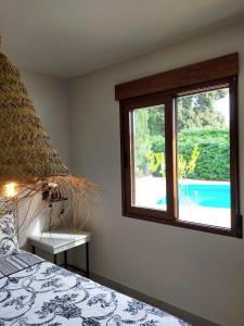 a bedroom with a bed and a window at Casa Francesca Altea piscina y aparcamiento privado in Altea