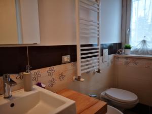 a bathroom with a sink and a toilet at B&B Vivere il Mare in Numana