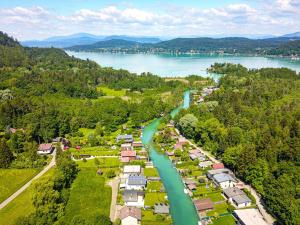 an aerial view of a village next to a river at Hotel Rösch in Klagenfurt