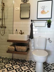 a bathroom with a white toilet and a sink at Apartment Radosevac Beach in Split