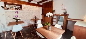 a dining room with two tables and white chairs at Zimmer Camere in Sirolo