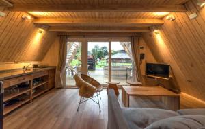 a living room with a couch and a table and a tv at Termas de Aguas Calientes in Puyehue