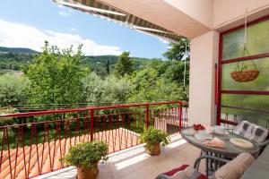 a patio with a table and chairs on a balcony at Apartment Nigra in Lovran