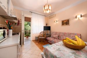 a living room with a couch and a table with bananas on it at Apartment Nigra in Lovran