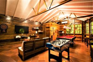 a room with a ping pong table and a room with a pool table at Ladera Resort in Soufrière