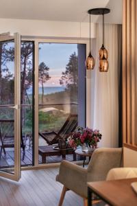 a living room with a sliding glass door to a patio at SEAVIEW - A Special Place For Two in Palanga
