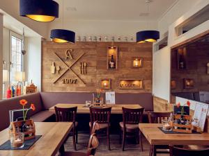 a dining room with wooden tables and chairs at Hotel Restaurant Clemens-August in Ascheberg