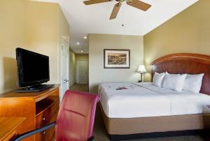a hotel room with a bed and a flat screen tv at La Quinta by Wyndham Marble Falls in Marble Falls