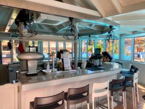 a bar in a restaurant with chairs around it at Jardín del Sol in Playa del Ingles