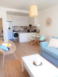 a living room with a blue couch and a table at ALMA Flat in Olhão in Olhão