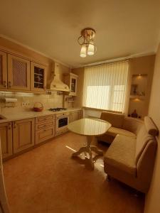 a kitchen with a couch and a table in a room at Apartment in historical centre in Odesa