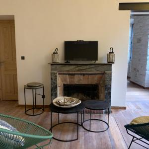 a living room with a fireplace with a flat screen tv at CASA CITADELLA Bonifacio in Bonifacio