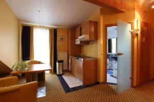 a small kitchen with a sink and a table at Au P'tit Max - Studios hotel in Luxembourg