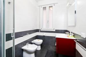 a bathroom with two toilets and a sink at Appartamenti Gherbin in Lido di Jesolo