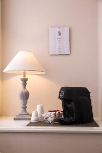 a table with a lamp and a printer on it at Royal Rooms Luxury Suite in Naples