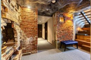 a room with a brick wall and a blue bench at Master Boutique Hotel in Moscow