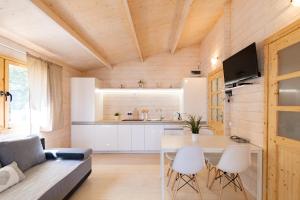 a kitchen and living room with a table and chairs at Marina Holiday in Ustka