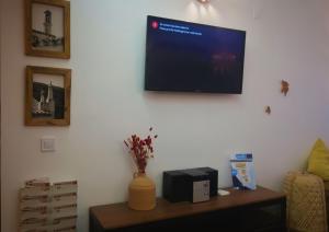 a flat screen tv hanging on a wall at Casa Barru in Albufeira