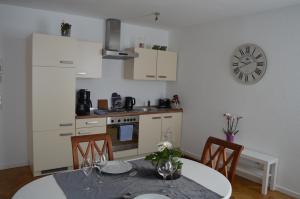 a kitchen with a table and a clock on the wall at Ludwig XIV in Saarlouis