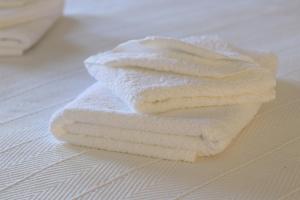 a stack of white towels sitting on a table at Michalis Studios in Lipsoi