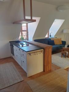 a kitchen with a island in the middle of a living room at Modernes Apartment an der Frauenkirche in Dresden