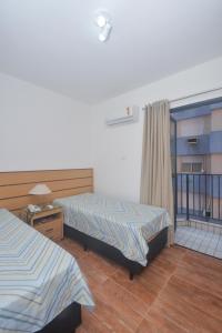 A bed or beds in a room at Flat Gonzaga Praia