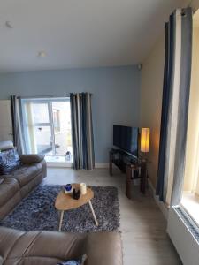 a living room with a couch and a coffee table at Atlantic Views Middle floor in Portrush