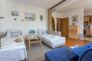 a living room with two beds and a table at So Hvar so Good! Spacious with terrace in Hvar