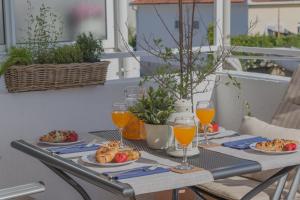 a table with plates of food and glasses of orange juice at So Hvar so Good! Spacious with terrace in Hvar