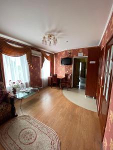 a living room with a couch and a table at Золотий Лев in Zvenyhorodka