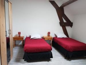 a room with two beds with red covers in it at Au coeur de nos campagnes in Lachapelle-Saint-Pierre +37 photos