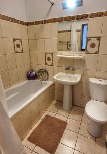 a bathroom with a tub and a toilet and a sink at Holiday Home SLAVIA NEW 600 z widokiem na morze in Międzyzdroje