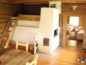 a room with a bunk bed and a table at Alkūnų sodyba in Molėtai