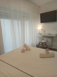 Łóżko lub łóżka w pokoju w obiekcie Rin Rooms