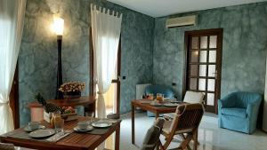 a living room with a table and chairs and a dining room at Sardinia B&B house in Olbia