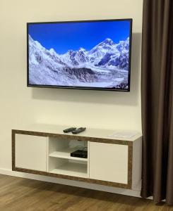 a flat screen tv hanging on a wall at Apartmánový dom Poludnica I., Chopok Juh, Jasná in Tale