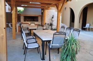 a patio with tables and chairs and a fireplace at M&M Apartments in Biograd na Moru