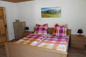 a bedroom with two beds and a painting on the wall at Ferienhaus Anni in Rot an der Rot