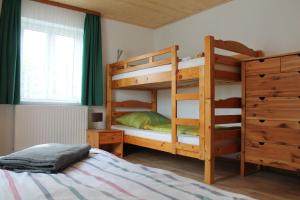 a bedroom with two bunk beds and a bed at Ferienhaus Anni in Rot an der Rot