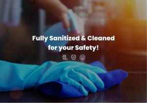 a person with a cleaning glove on a counter at Hai Hotel in Larnaca
