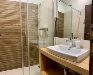 a bathroom with a sink and a shower at Apartmánový dom Poludnica I., Chopok Juh, Jasná in Tale +36 photos