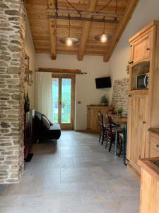 a living room with a couch and a table at LA DRIT in Paesana