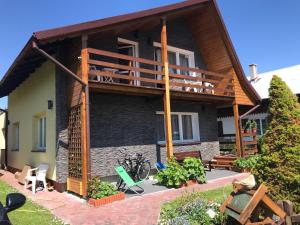 a house with a balcony on the side of it at A&R Brzozowa 5 in Rowy