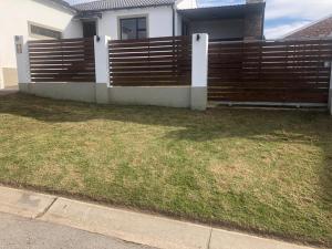 a wooden fence in front of a house at Mount Pleasant Suites in Port Elizabeth